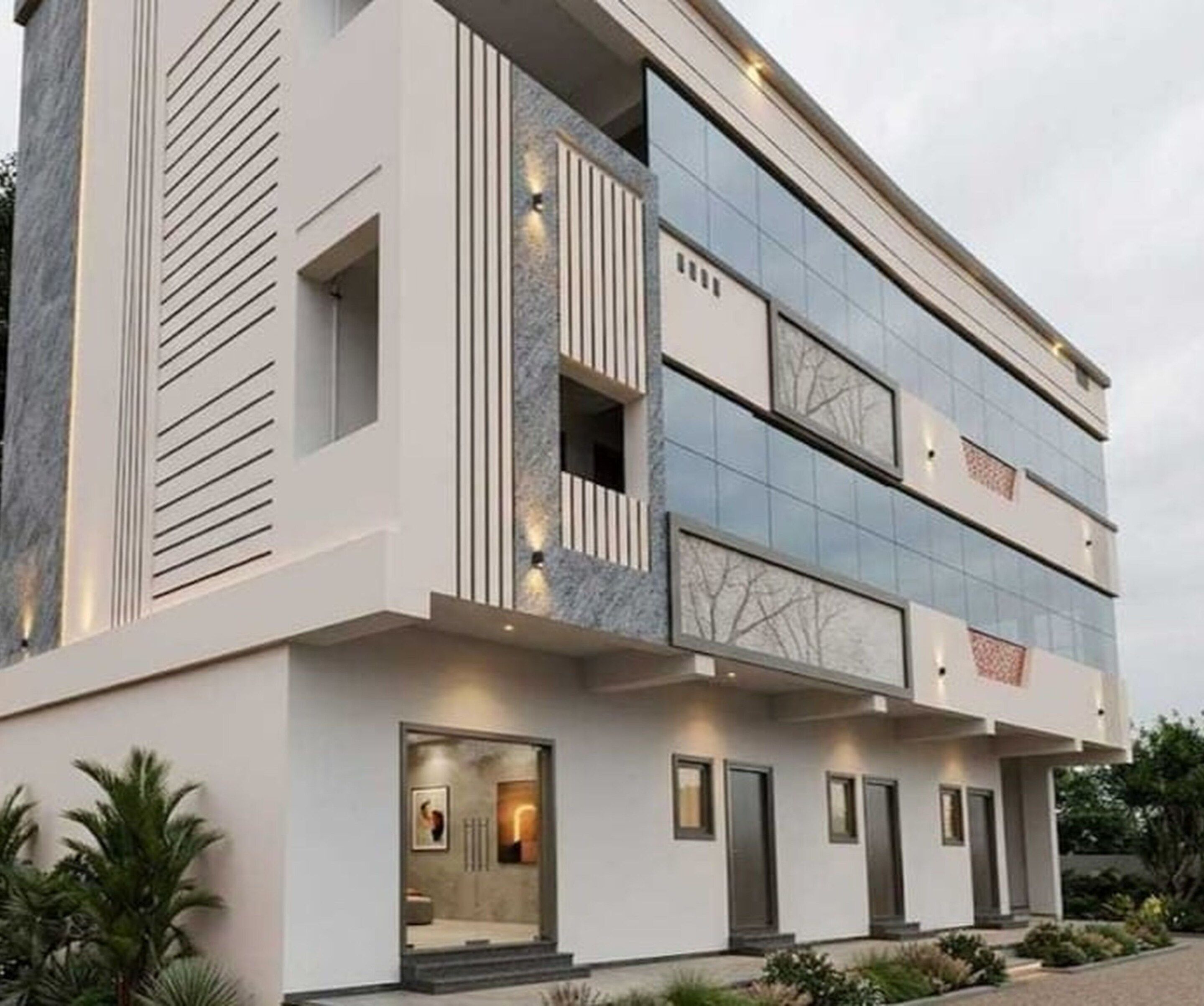 A modern two-story building with a flat roof, large windows, and a symmetrical facade.