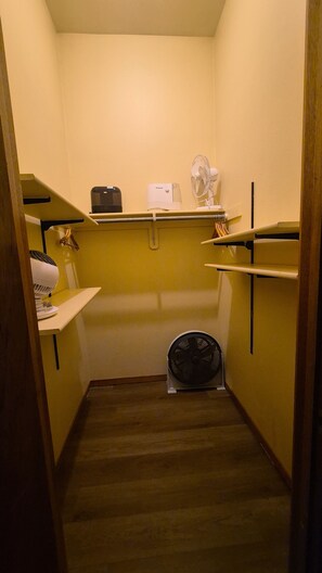 A small, narrow room with wooden flooring, a white heater, a white fan, and a black heater on a shelf. - Lovely 2-bedroom condo next to Teton Village/Skii Mountain Resort (Wilson)