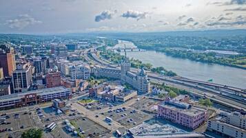A cityscape with a river, bridges, and a mix of modern and historic buildings.