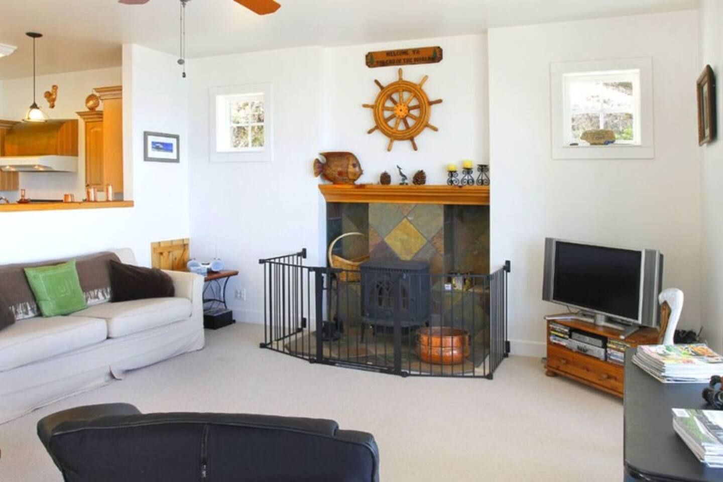 A living room with a fireplace, a television, and a sofa.