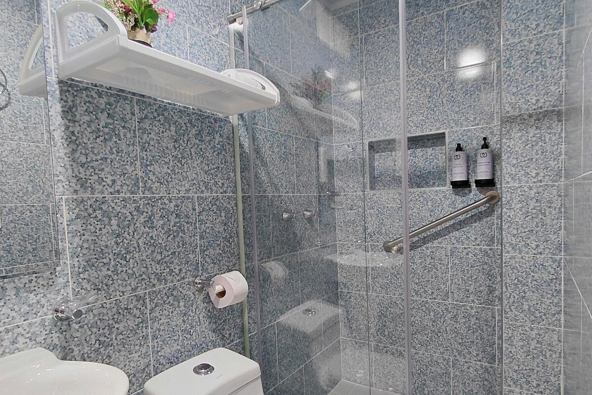 Habitación doble de diseñador | Baño | Pantuflas, jabón, shampoo, papel de baño 