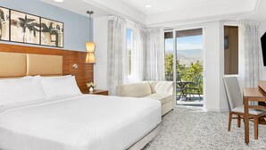 A hotel room with a large bed, a sofa, a dining table, and a view of the outdoors. - Marriott Vacation Club- large 2 bd 2ba unit (Palm Desert)