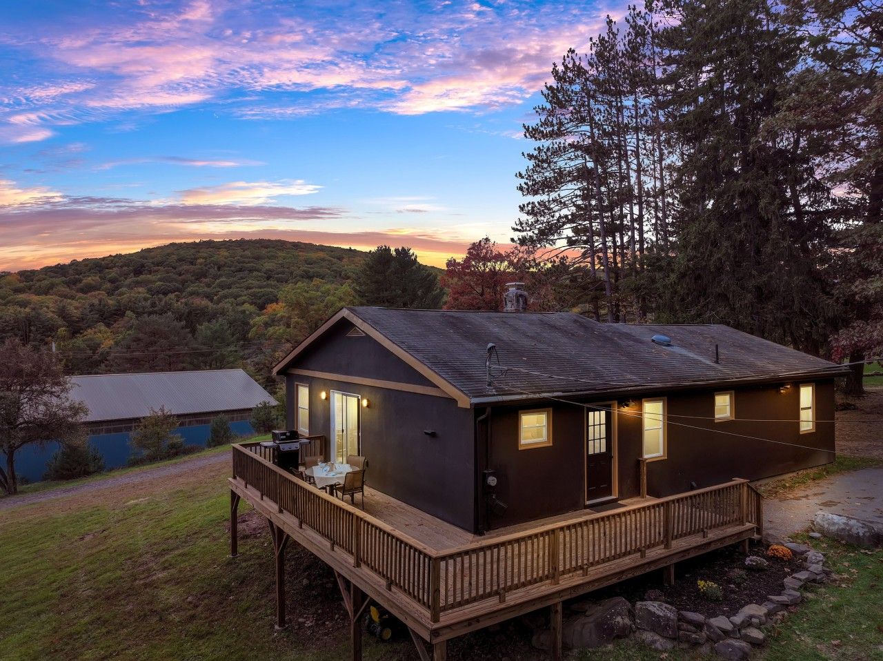 Your cabin at dusk, with a wraparound deck
