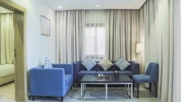 A modern living room with a sofa set, a coffee table, and a lamp.