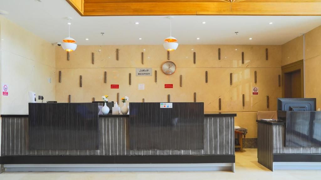 A reception area with a reception desk, a clock, and a sign indicating 'RECEPTION'.