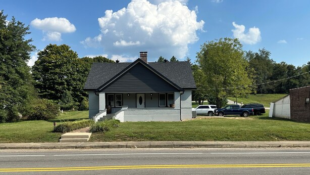 A residential house with a front porch, a chimney, and a driveway with two cars parked. - Newly Renovated House in Buffalo, Ky (Buffalo)