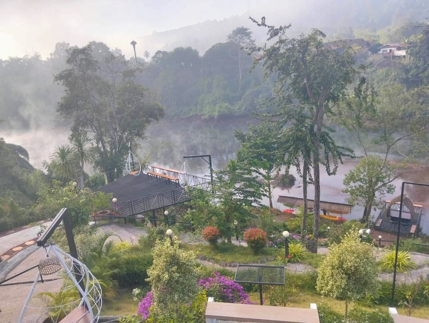 A view of a mountainous area with a bridge, a gazebo, and a gazebo with a roof.