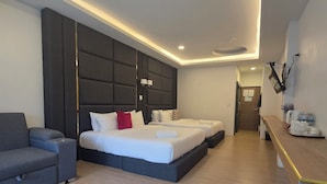 Ein modernes Hotelzimmer mit einem Bett, einer Couch, einem Schreibtisch und einem Badezimmer.