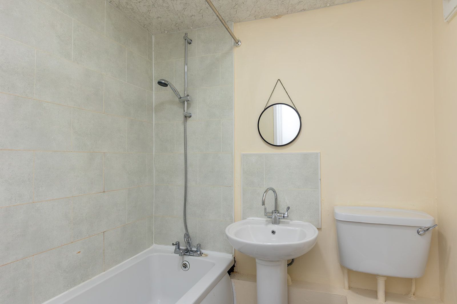 A bathroom with a bathtub, a sink, and a toilet.