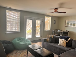 A living room with a sofa, bean bag, and a ceiling fan. - New listing discount! Sunny Shores on Hartwell- Dock, kayaks, pedal boat, games (Martin)