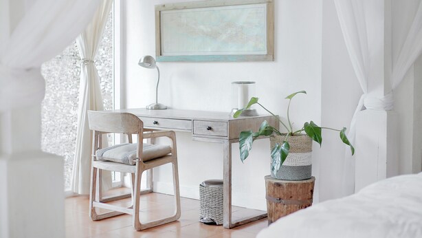 A bedroom with a bed, a desk, a chair, a lamp, and a plant. - 752 Ocean Ave  Unit A & B (Wells)