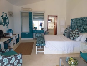 A bedroom with a bed, bedside table, and a wardrobe. - The One Watamu Bay (Watamu)