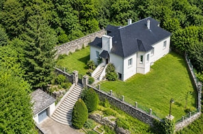 A large, two-story house with a stone wall and a well-maintained lawn. - Ti Ar Meliner – In the Heart of Brittany’s Natural Beauty (langonnet)