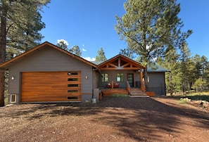 A two-story building with a garage, a covered porch, and a small shed. - Large Modern Mountain Lodge in Forest near Lake Mary - Sleeps 12 - Pets OK (Flagstaff)