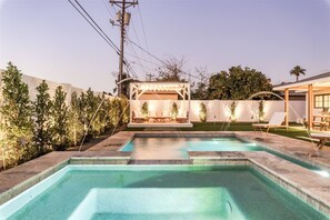 A backyard with a swimming pool, a covered seating area, and a barbecue setup. - Reesor: Scottsdale Home with Private Pool & Spa (Scottsdale)