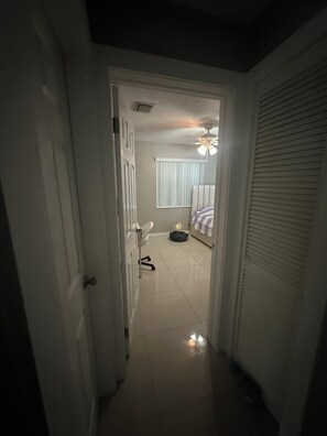A hallway leading to a bedroom with a bed, a ceiling fan, and a window with blinds. - 2 bedroom house , one bedroom
Available small dog on property plenty of parking (Hollywood)