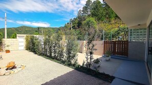 Il s’agit d’une propriété résidentielle dotée d’une allée pavée, d’une clôture en bois et offrant une vue sur un paysage vallonné.
