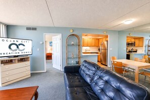 A compact living space with a kitchenette, a dining area, and a seating area. - Golden Sands 1617 (Ocean City)