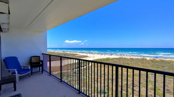 A balcony with a view of a beach and ocean. - Updated Beachfront Escape at Embassy #402 - Intimate 30-Unit Complex (South Padre Island)
