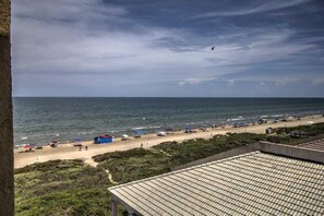 A beach with umbrellas and beach chairs, a clear sky, and a view of the ocean. - Beachfront Studio at Florence 1 #608 - Incredible Gulf Views & Resort Comfort (South Padre Island)