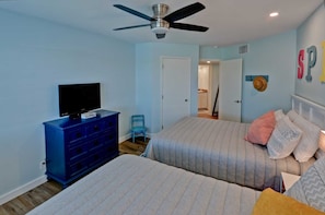 A bedroom with two beds, a TV on a dresser, and a ceiling fan. - Gulfpoint #3209 - Spacious 2-BR Family Escape Near Beach Park At Isla Blanca (South Padre Island)