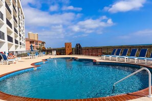 A swimming pool with lounge chairs and a view of the beach. - Secure 3-BR Family Escape at Seville #603 - Beachfront with 2 Pools (South Padre Island)