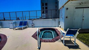 A rooftop pool area with lounge chairs and a hot tub. - Secure 3-BR Family Escape at Seville #603 - Beachfront with 2 Pools (South Padre Island)