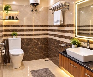 A modern bathroom with a toilet, sink, and shower.