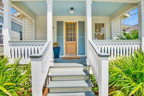 A two-story house with a porch, a wooden front door, and a mailbox. - The Pearl Downtown Retreat (Mobile)
