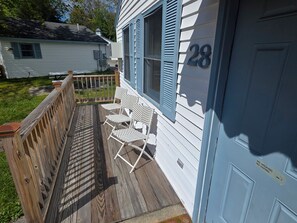 A wooden deck with two white chairs, a number 28 on the door, and a 'No Smoking' sign. - Amazing 1-bedroom Condo with AC in cozy Saco (Saco)