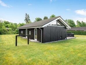 A modern building with a sloped roof, a large window, and a dark exterior. - "Tobias" - 30km from the sea by Interhome (Toftlund)