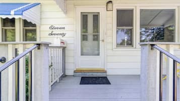 A front porch with a white door, a mailbox, and a sign reading 'Eleven Seventy'.