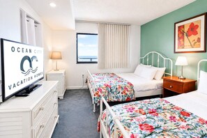 A hotel room with two beds, a TV, and a window with curtains. - Golden Sands 1611111 (Ocean City)