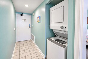 A laundry room with a washing machine, a dryer, and a door with a lock. - Golden Sands 1611111 (Ocean City)