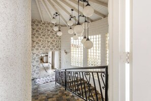A staircase with a patterned wall and hanging light fixtures. - ZAINALAND!! Mythic Desert Den!! (Twentynine Palms)