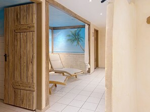 A room with a wooden door, a view of the sea with a palm tree, and a tiled floor. - Brünnsteinzauber by Interhome (Oberaudorf)