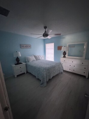 A bedroom with a bed, nightstands, a dresser, a ceiling fan, and a window. - 2 Bedroom Siesta Key Condo Private Beach Access, Pool & Tiki Bar (Sarasota)