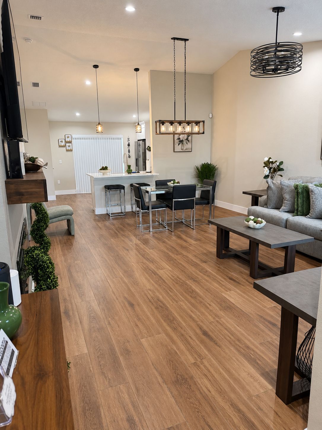 A modern living space with a dining area, a sofa, and a coffee table.