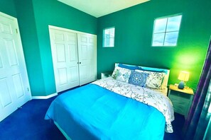 A bedroom with a bed, a nightstand, a window, and a door. - 3310 Tremendous 3-bedroom house with AC in San Jose (San Jose)