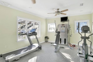 A home gym with a treadmill, elliptical, and weight machine. - Southern Comfort (Mobile)