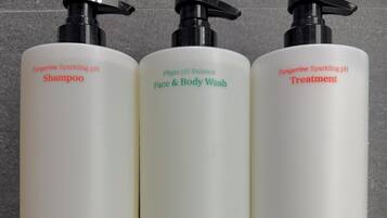 Three bottles of Amayzl products on a white shelf.