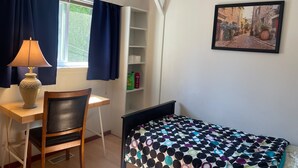 A small bedroom with a desk, chair, bed, and a window with curtains. - Room-pretty Room -shared Accommodation (Coquitlam)