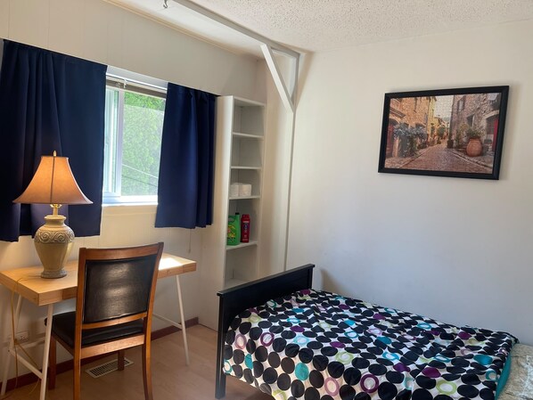 A small bedroom with a desk, chair, bed, and a window with curtains. - Room-pretty Room -shared Accommodation (Coquitlam)