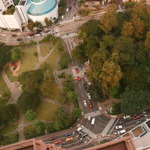 An aerial view of a complex intersection with multiple roads, a roundabout, and surrounding greenery. - Tropical Retreat • 24F Balcony • Sauna • Gym • Greenbelt • Makati (Makati)