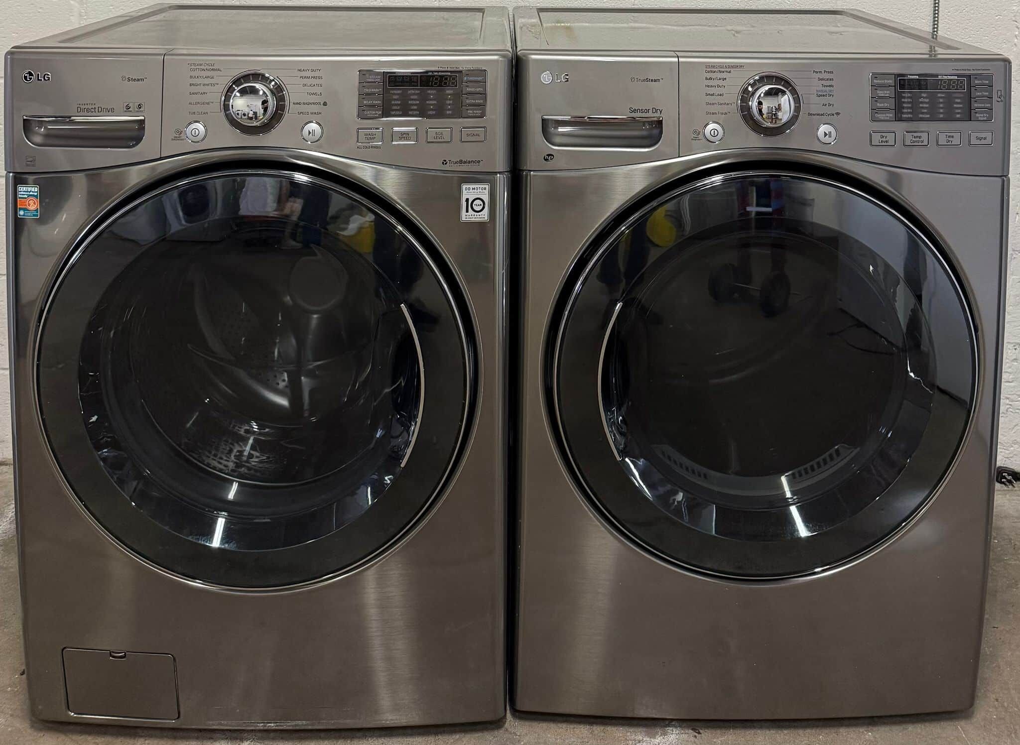 Two stainless steel LG Direct Drive front-loading washing machines.