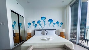 A modern bedroom with a large bed, a glass wall, and a ceiling mural of jellyfish. - The Bloom - Oceanfront King Suite (Montego Bay)
