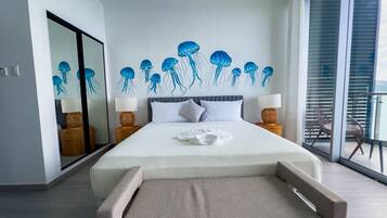 A modern bedroom with a large bed, a glass wall, and a ceiling mural of jellyfish.