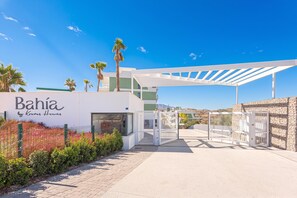 A modern Bahía by Kronos Homes building with a white facade, a covered entrance, and a view of the surrounding landscape. - Bahia La Cala Paradise And Sunshine, La Cala de Mijas, Spain (La Cala de Mijas)