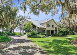 A two-story house with a covered porch, a pathway leading to the entrance, and a well-maintained lawn.