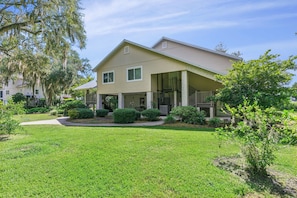 A two-story house with a covered porch and a well-maintained lawn. - Heron's Perch - Marsh Front (Pet Friendly) (Waverly)